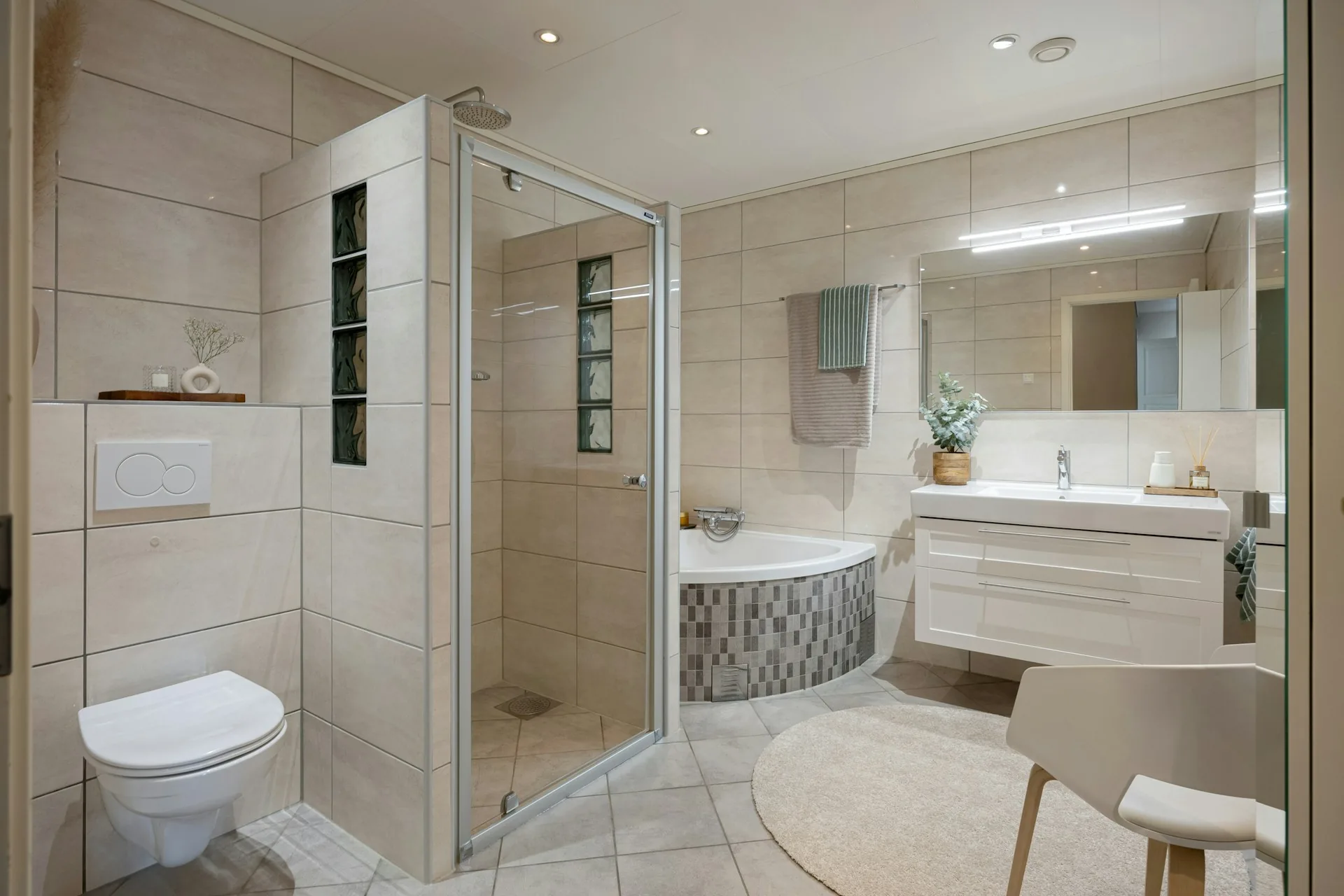 Tiled bathroom with walk-in shower and floating vanity